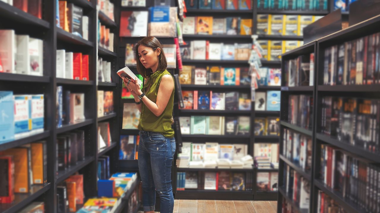 A woman inspecting a book in a bookstore