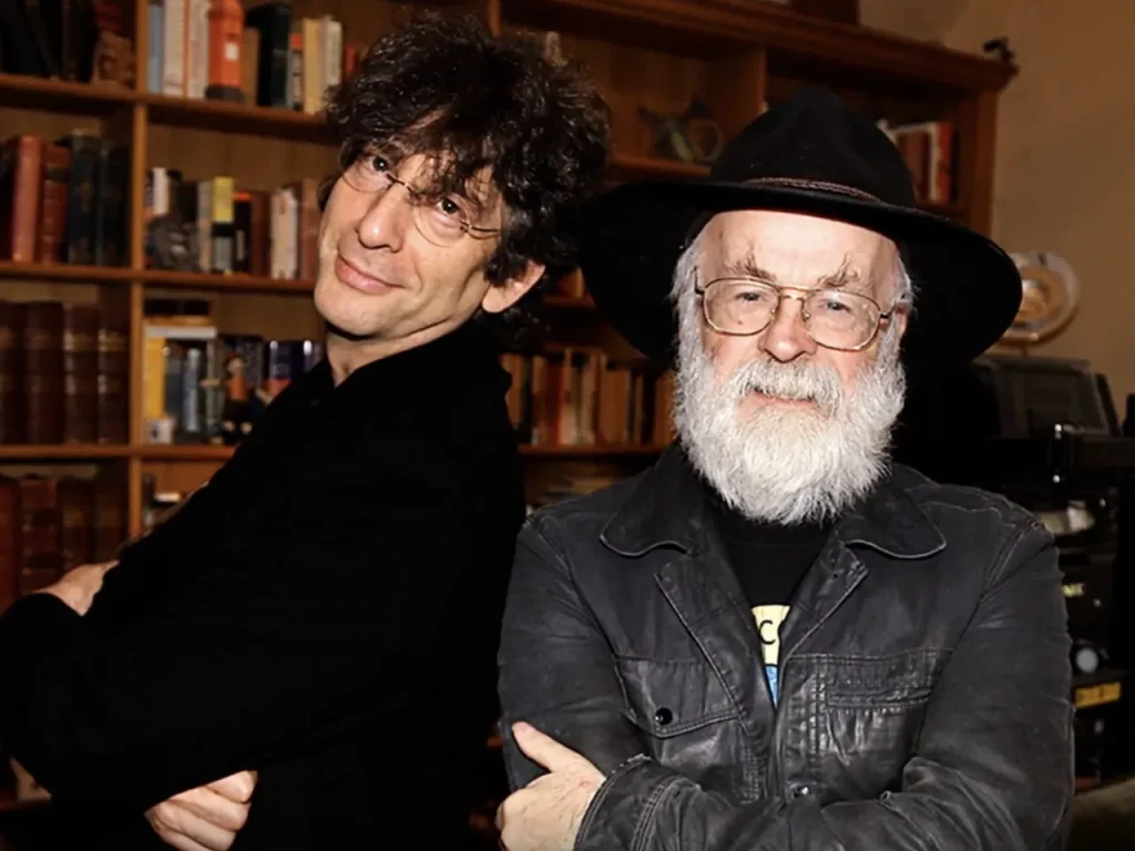 Neil Gaiman (left) and Terry Pratchett (right) with bookshelf in background