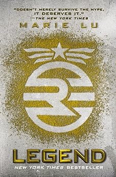 legend-marie-lu-book-cover-pattern-of-"r"-in-circle-on-grainy-gold-background-with-winged-star-emblem-above-gray-backdrop