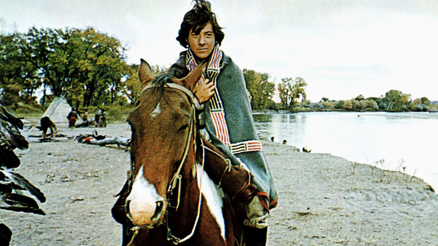 Dustin Hoffman sitting atop a horse on the set of Little Big Man movie.