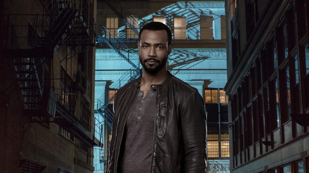 Luke Garroway from Shadowhunters dressed in leather and black looking into the camera. 