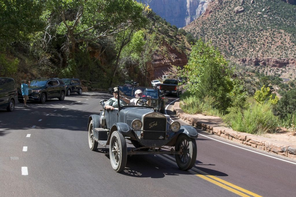 A Ford Model T being driven down a mountain road.
