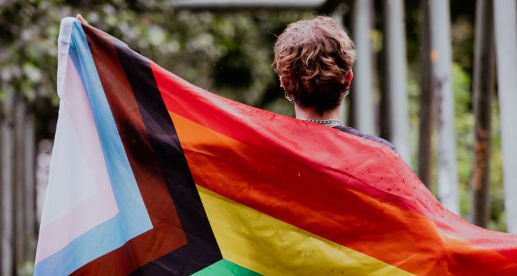 person holding a pride flag
