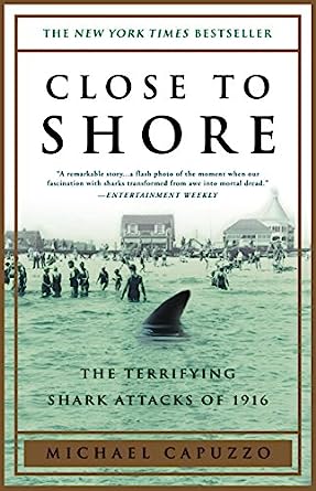close-to-shore-michael-capuzzo-book-cover-shark-fin-in-foreground-crowded-beach-in-background