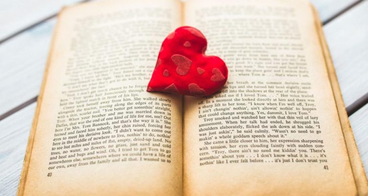 open book with a heart in the center showing a story