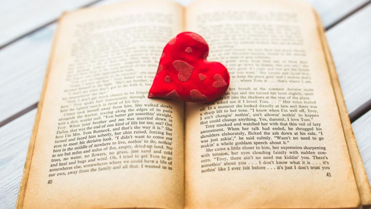open book with a heart in the center showing a story