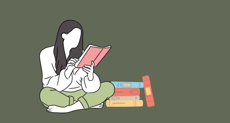 woman cross legged reading a book with a stack of books next to her