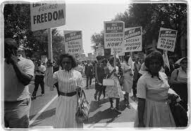Black women marching for suffrage with signs