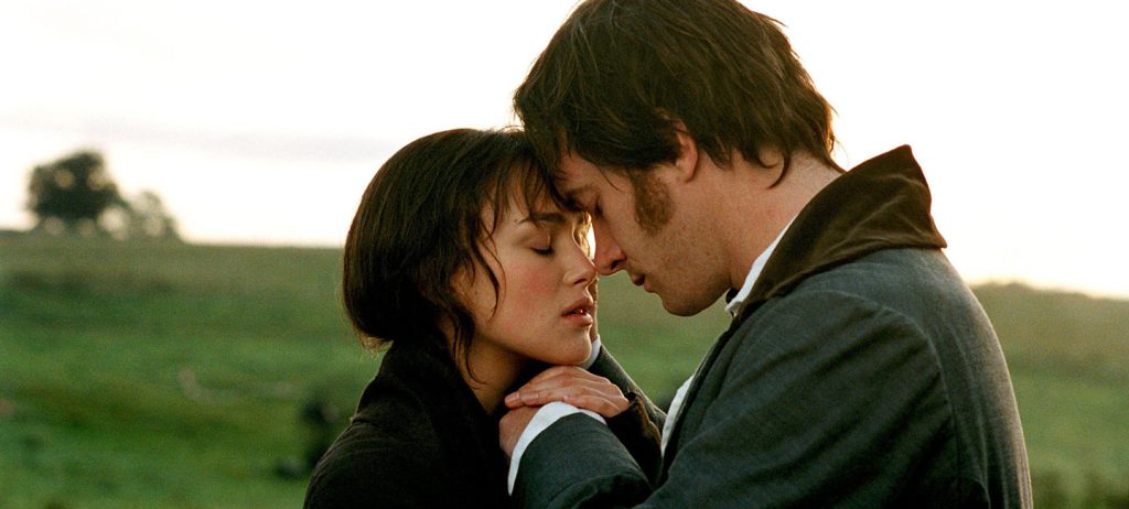 Focus Features Pride and Prejudice Elizabeth and Mr. Darcy in the field holding each other by the hands 