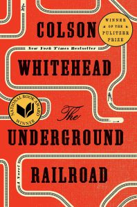Underground Railroad by Colson Whitehead cover, orange background with train tracks circling words