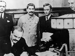 Soviet Union Foreign Minister Vyacheslav Molotov signing Molotov-Ribbentrop Pact with German Minister of Foreign Affairs Joachim von Ribbentrop and Soviet Union Premier Joseph Stalin