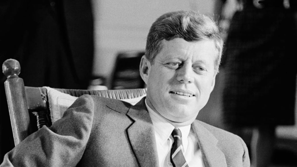 John F. Kennedy sitting in a chair