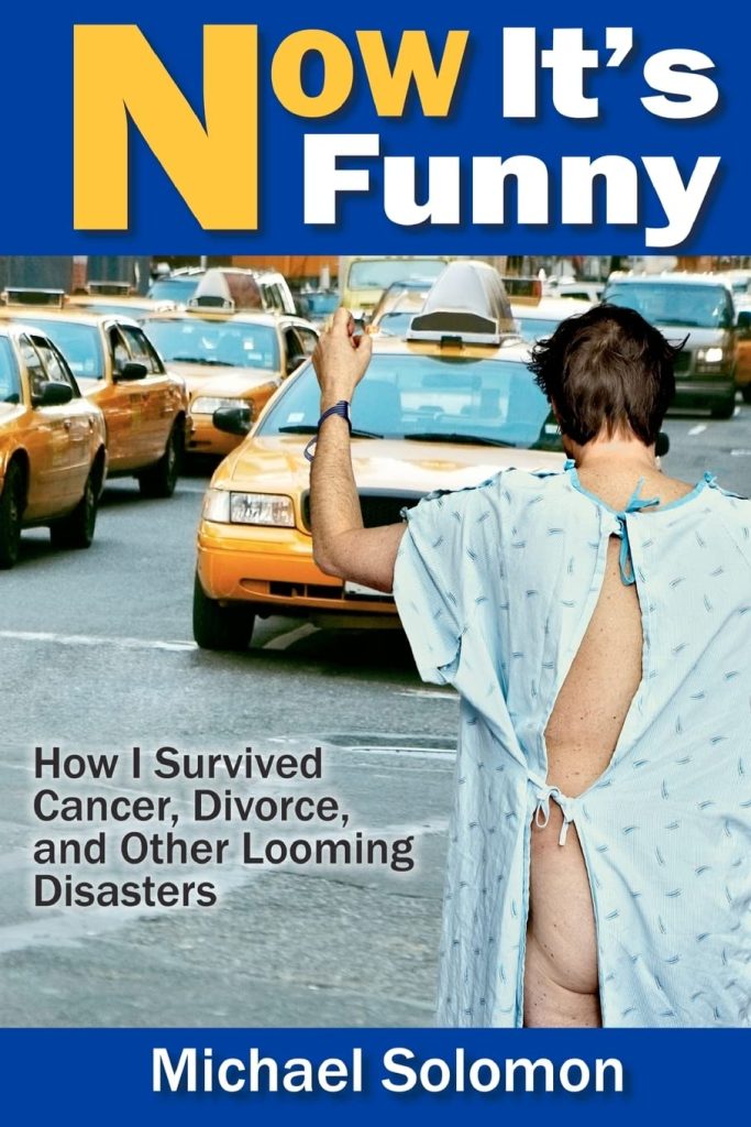 book cover of now it's funny by michael solomon a man in a hospital gown with one butt cheek hanging out in the middle of a new york taxi rush