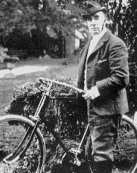 Queensberry standing next to bicycle