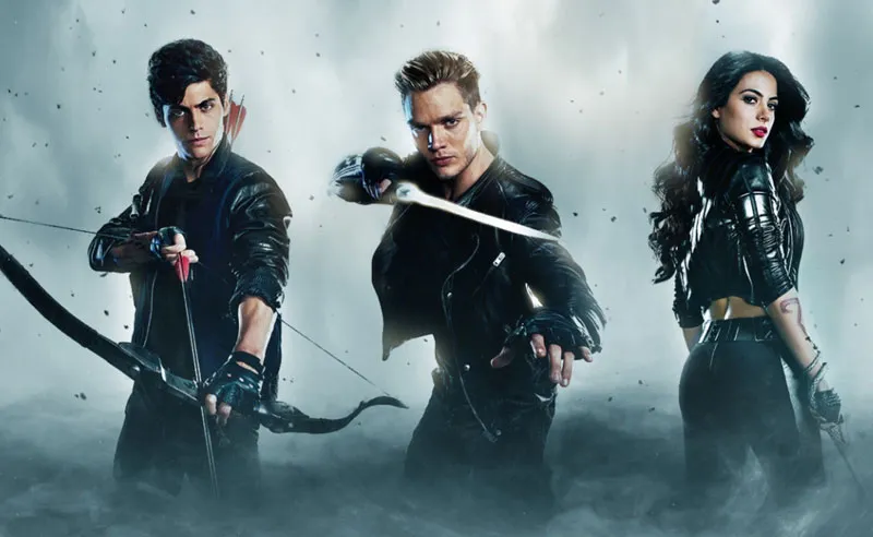 Alex, Jace, and Isabelle from the TV show Shadowhunters with a bow, sword, and snake whip.