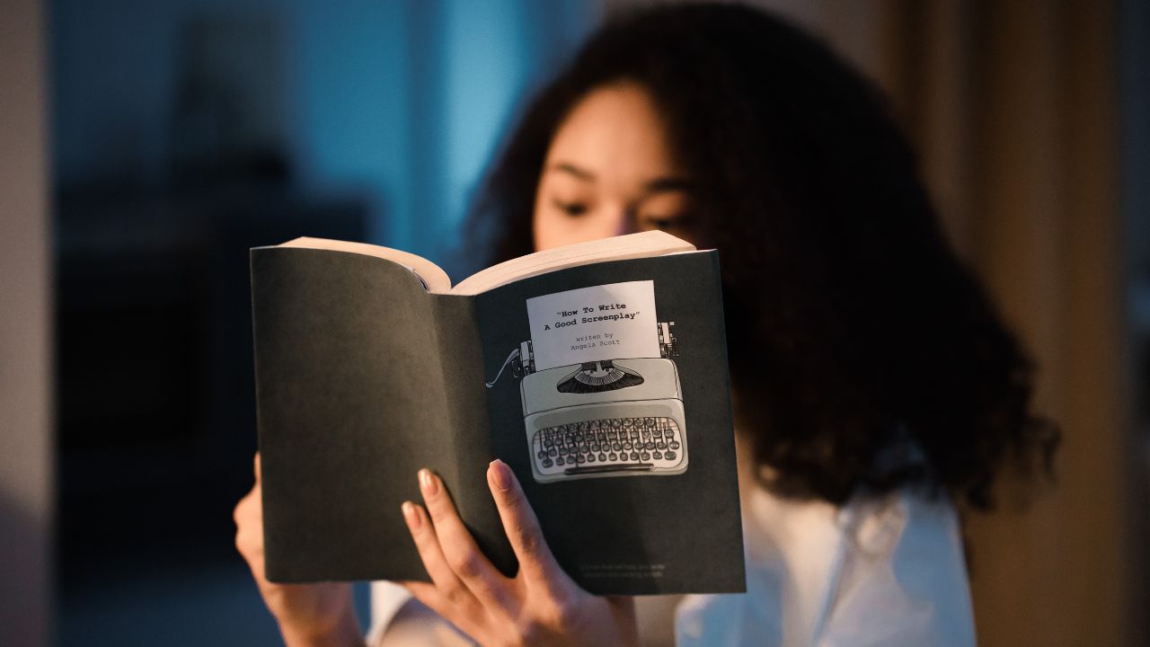 A girl reading a book about how to write a screen play.