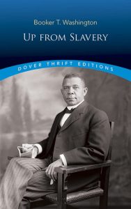 Up from Slavery cover by Booker T. Washington with a man in a suit in a chair on the cover that is Booker T. Washington himself.