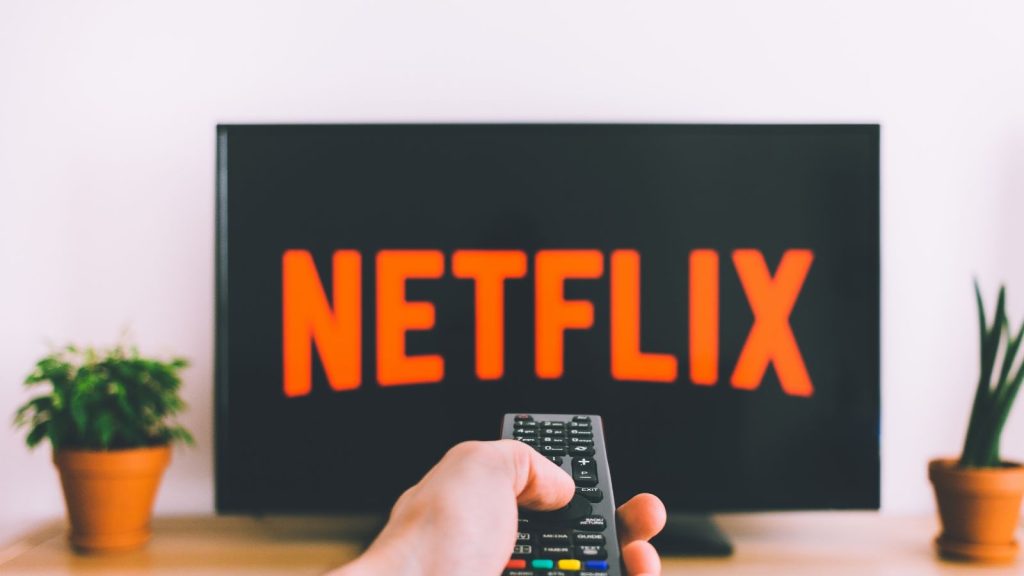 Pointing remote at TV to watch Netflix.