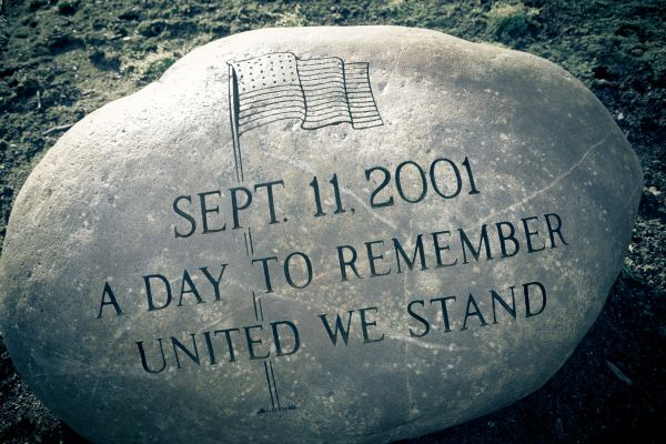 9/11 Memorial etched into a large rock. September 11, 2001. A Day to remember United We Stand.