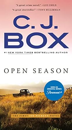 Open Season by CJ Box cover; old truck driving through grassland with mountains in background