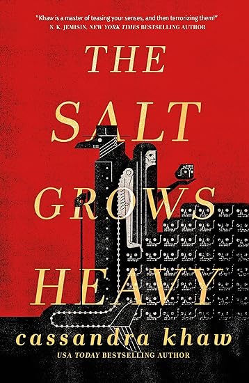 A red and black cover with two well-dressed creatures in the center. The title is in yellow across the creatures- one male holding a cane, the other female holding an object in her hand. There is an eerie feel to the cover with a sophisticated air about it.