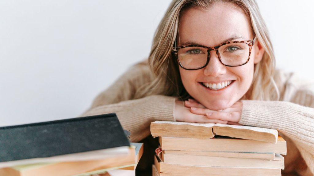 Happy woman with books
