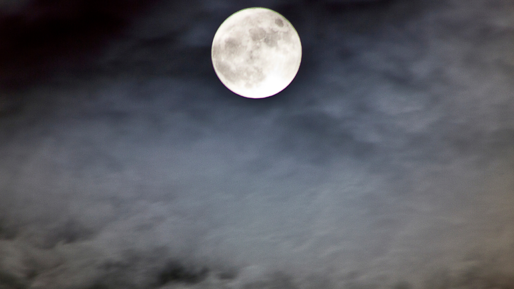 Moon shining on a cloudy sky 