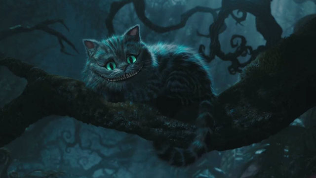 The Cheshire Cat sitting on a branch in the dark woods with twisted tree limbs in the background.