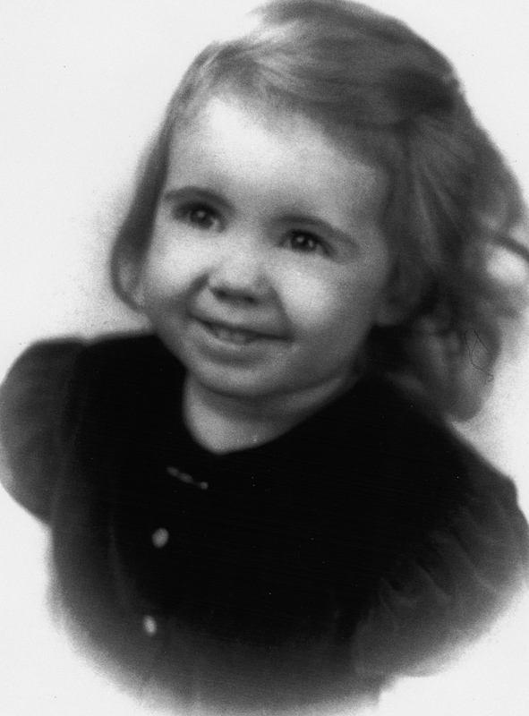 Anne Rice as a toddler in a black and white portrait.