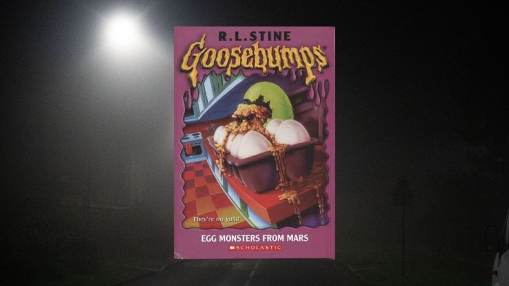 A small lit background with Egg Monsters from Mars Cover in middle. Cover has a carton of regular eggs, but one green egg with a yellow eyed liquid spilling out. 
