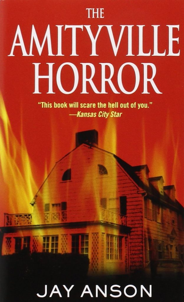 The Amityville Horror cover by Jay Anson, the Amityville house overlaid with red flames.