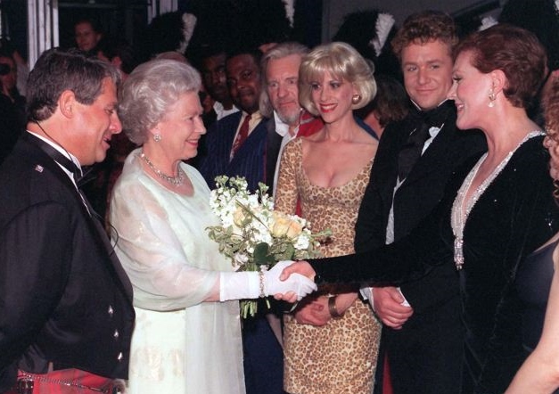 Image shows Julie Andrews shaking hands with the late Queen Elizabeth II at an event.
