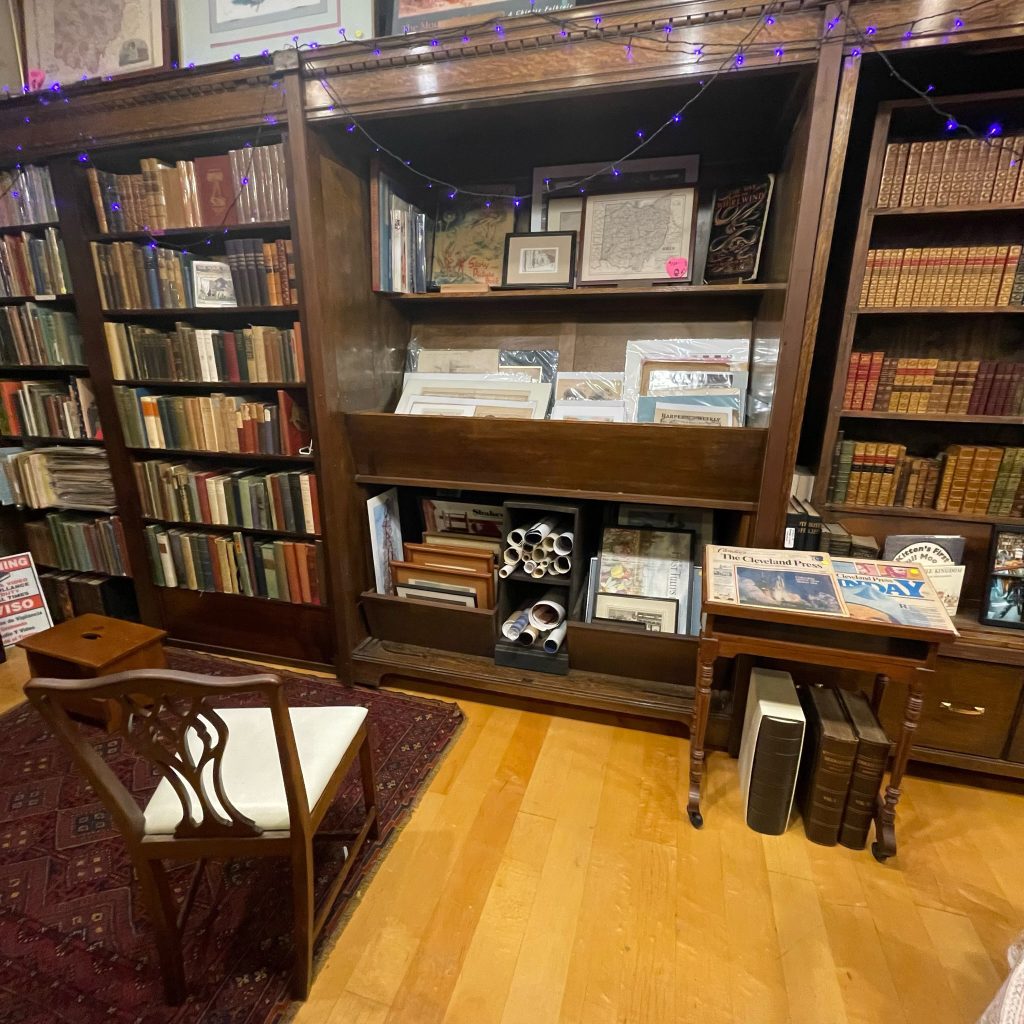 Beautiful wood bookshelves and display case of antique and rare books.