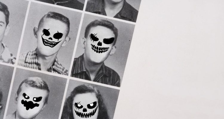 a gray-toned grid of yearbook photos with black ghoul face stickers laid over blank faces.