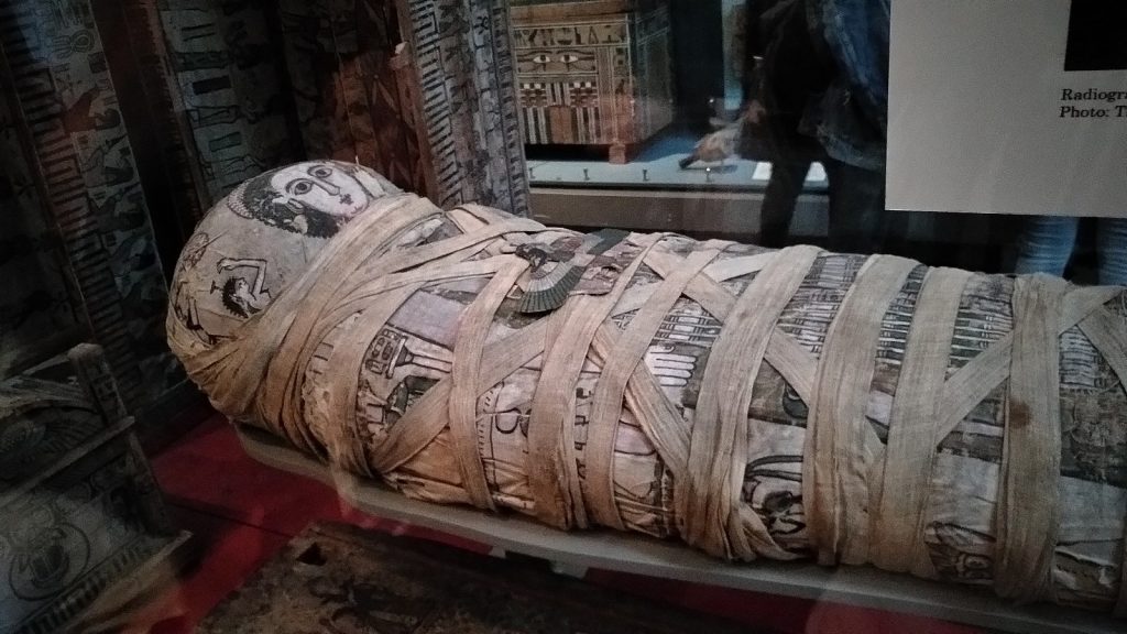 A mummified body is wrapped in many layers of protective covering and artistic designs.