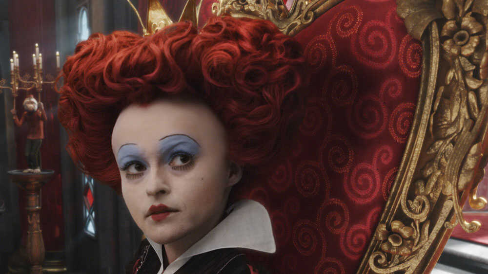 Queen of Hearts from Alice in Wonderland with red hair in the shape of a heart and blue eyeshadow.