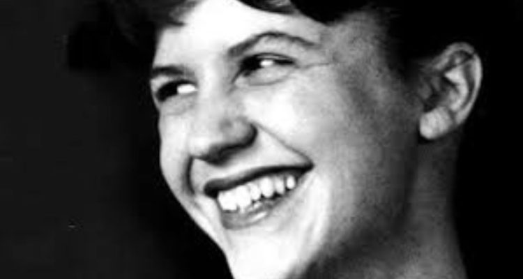 Closeup black and white photo of Sylvia Plath smiling