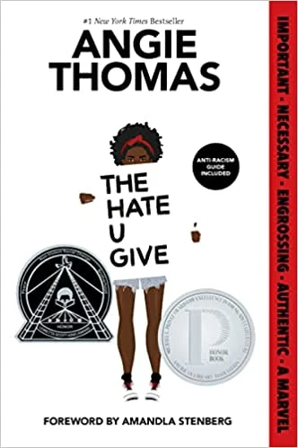 The Hate U Give cover by Angie Thomas with a dark-skinned girl on the front holding a sign with the book title.