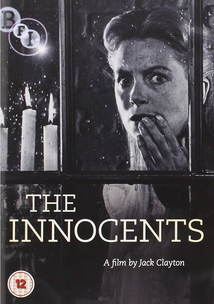 The Innocents promotional photo, woman looking out a window and holding a hand to her face.