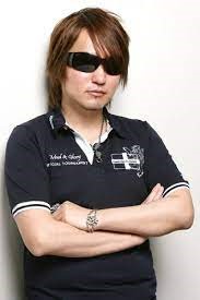 Tite Kubo wearing sunglasses and crossing his arms
