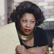 Toni Morrison looking off to the side and holding a piece of paper.
