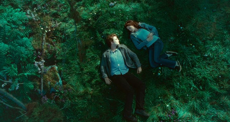 Bella Swan and Edward Cullen laying in a meadow in the Twilight movie adaptation of the same name.