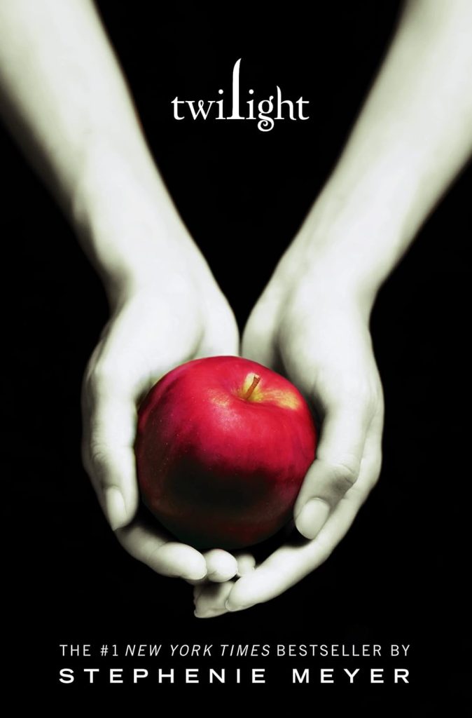 Two hands cup an apple for the cover art of Twilight.