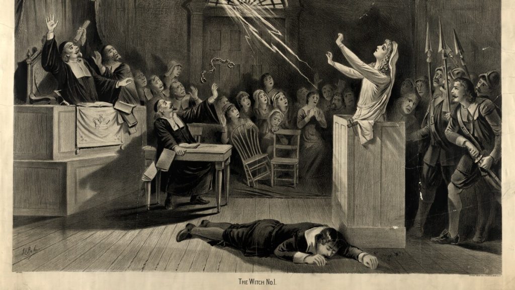 Drawing of Salem Witch Trials; courtroom in which woman in front of man lying on floor expels lightning from hands and viewers scream