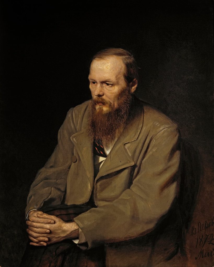 Oil portrait of Fyodor Dostoyevsky in front of a black background wearing a tan suit