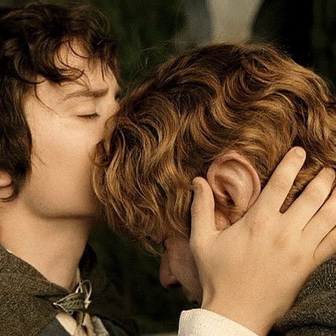 Frodo kisses the top of Sam's head. It looks very endearing.