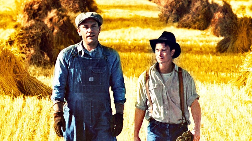 1992 'Of Mice and Men' movie showing George Milton and Lennie Small walking with a field behind them