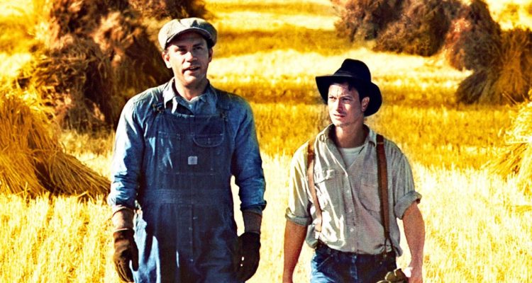 1992 'Of Mice and Men' movie showing George Milton and Lennie Small walking with a field behind them