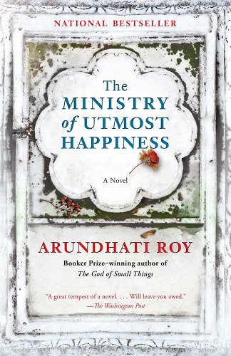 'The Ministry of Utmost Happiness' by Arundhati Roy book cover that looks like the cover of another book with a rose and title inside a flower shape