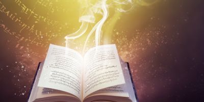 An open book with white smoke emitting from the pages. Written characters surround the book. Mists of gold-white spray from the book. The background is dark and mystical.